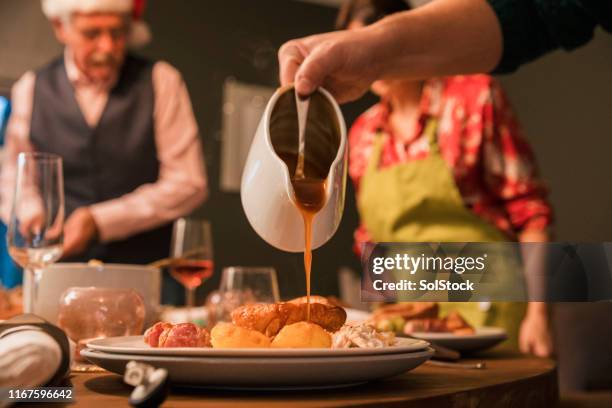 completing the meal with gravy - savoury sauce stock pictures, royalty-free photos & images