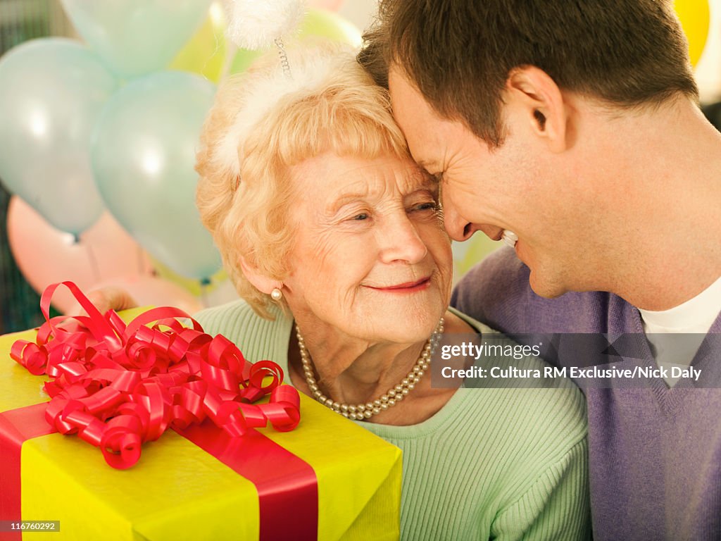 Mother and son hugging at birthday party