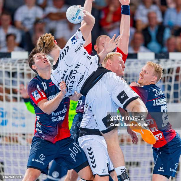 Lukas Nilsson challenges Magnus Röd during the Liqui Moly HBL match between THW Kiel and SG Flensburg-Handewitt at Sparkassen Arena on September 12,...