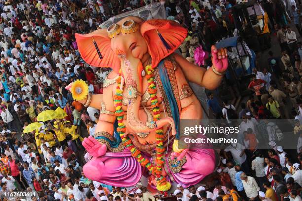 Devotees carry a statue of elephant-headed Hindu god Ganesha, for immersion into the Arabian Sea, on the final day of the Ganesh Chaturthi festival...