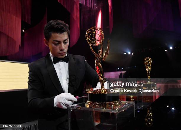 Worker removes a plaque from a Emmy Award statue in the engraving station during 71st Emmy Awards Governors Ball and 2019 Creative Arts Governors...