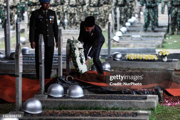 Indonesian President Joko Widodo lays a wreath at the grave of former Indonesian President B.J. Habibie during his funeral ceremony at Kalibata...