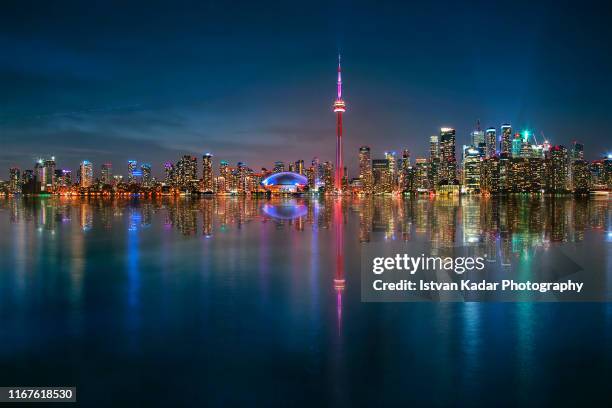 illuminated toronto city and its reflection - lake ontario stock pictures, royalty-free photos & images