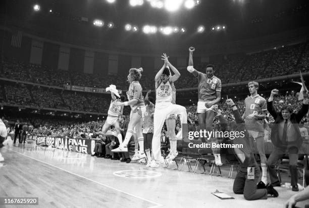 The North Carolina bench erupts with joy with 15 seconds to go as a jump shot by Carolina's Michael Jordan gives the Tar Heels a 63-62 victory over...