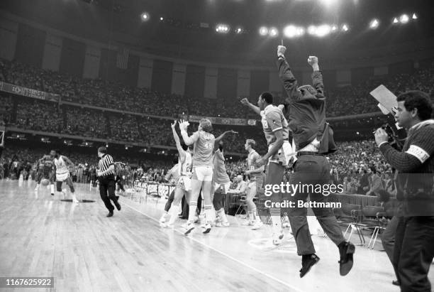 The North Carolina bench erupts with joy with 15 seconds to go as a jump shot by Carolina's Michael Jordan gives the Tar Heels a 63-62 victory over...