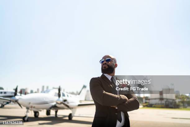 confident man looking away in a hangar - best sunglasses for bald men stock pictures, royalty-free photos & images