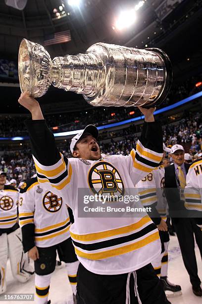 Jamie Arniel of the Boston Bruins celebrates as he lifts the Stanley Cup after defeating the Vancouver Canucks in Game Seven of the 2011 NHL Stanley...