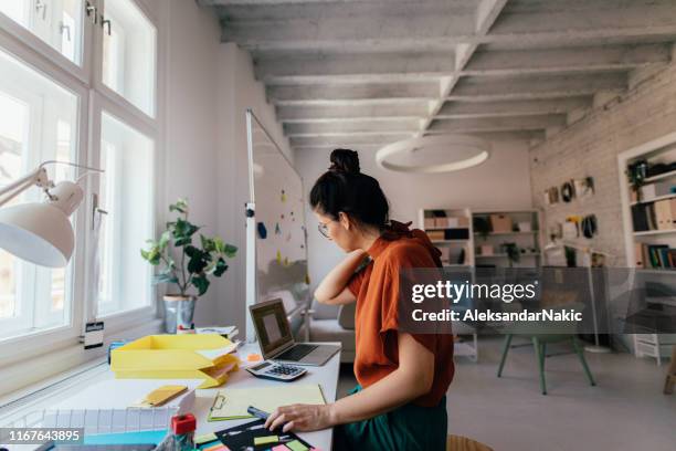 jonge vrouw werkzaam in een modern kantoor - cool office stockfoto's en -beelden