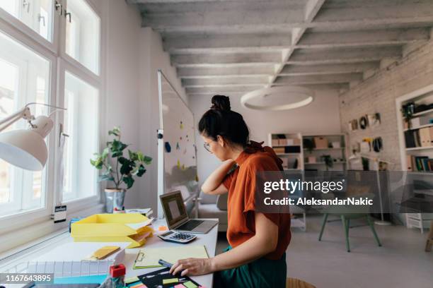 young woman working in a modern office - architect desk stock pictures, royalty-free photos & images