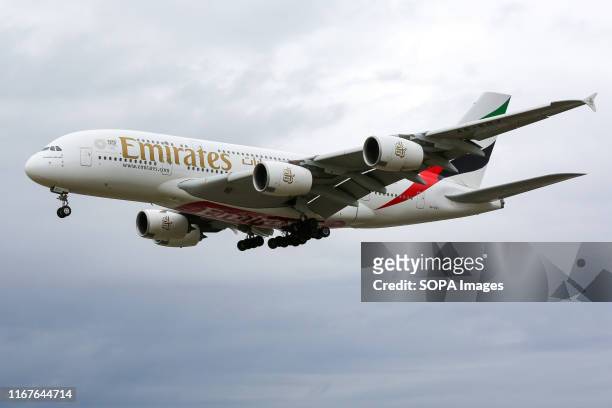 An A380 Emirates Airline plane approaching London Heathrow Terminal 3 airport.