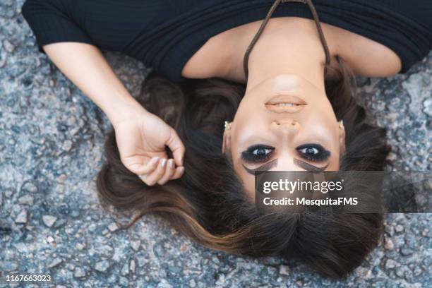 fashion model lying on the asphalt - black eyeshadow stock pictures, royalty-free photos & images