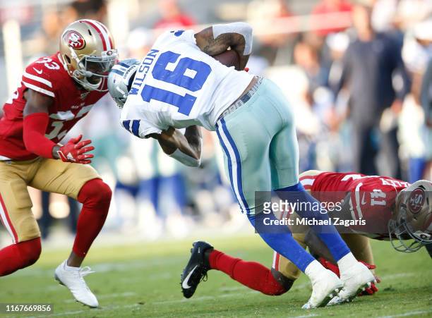 Tarvarius Moore of the San Francisco 49ers tackles Cedrick Wilson of the Dallas Cowboys during the game at Levi's Stadium on August 10, 2019 in Santa...