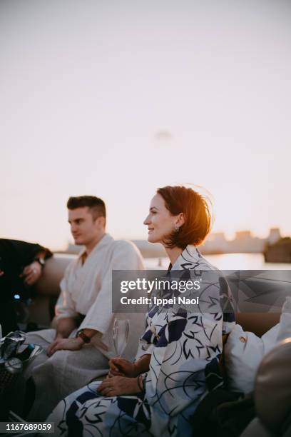 caucasian woman wearing kimono on boat at sunset, tokyo bay - kimono imagens e fotografias de stock