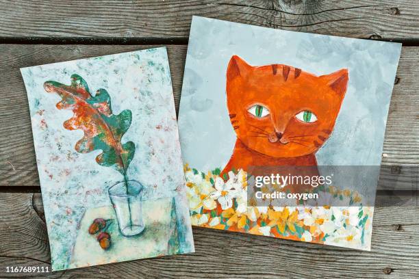 two illustration on a wooden background. flatlay composition with stones and woods. ginger cat with white flowers. - pintura em tinta acrílica imagens e fotografias de stock
