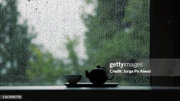 teapot and cup at rainy window - window rain stock pictures, royalty-free photos & images