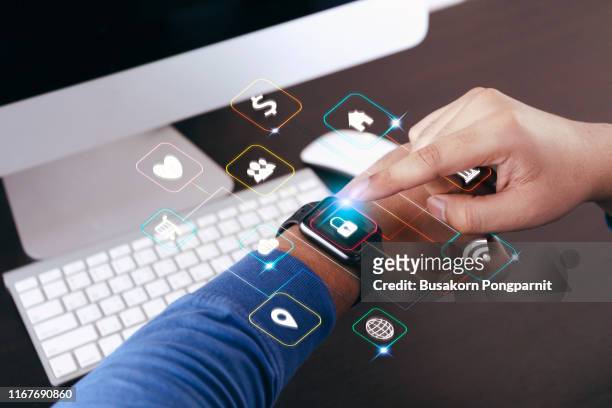 hand with smartwatch and application symbols nearby. data digital technology concept - smart watch on wrist stock pictures, royalty-free photos & images