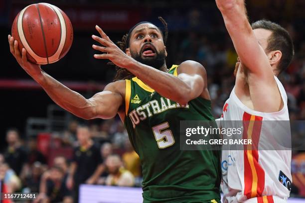 Australia's Patty Mills fights for the ball with Spain's Victor Claver during the Basketball World Cup semi-final game between Australia and Spain in...