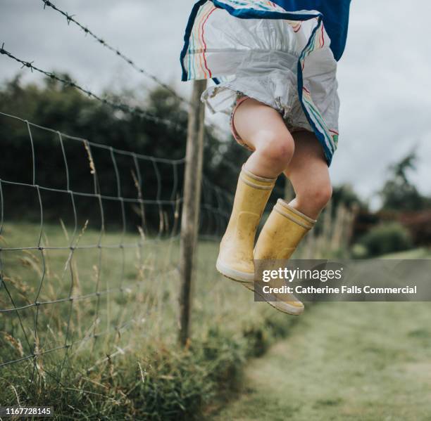 wellies - yellow boot stock pictures, royalty-free photos & images