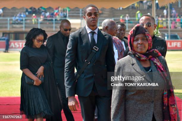 The children of Zimbabwe's former President, the late Robert Mugabe, Robert Junior , Chatunga and Bona arrive at Rufaro stadium on September 13, 2019...