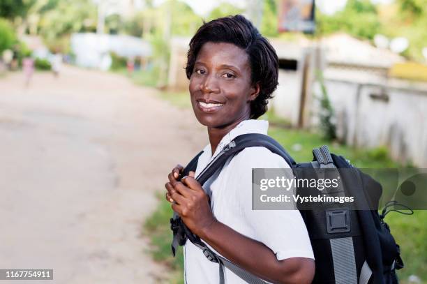 travel, tourism - smiling young woman with backpack ready to hit the road. - costa de marfil fotografías e imágenes de stock