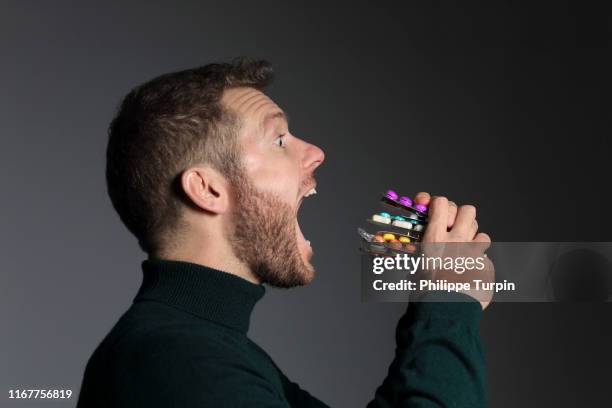 30 years old man eating medicine sandwich - birth control pill bildbanksfoton och bilder