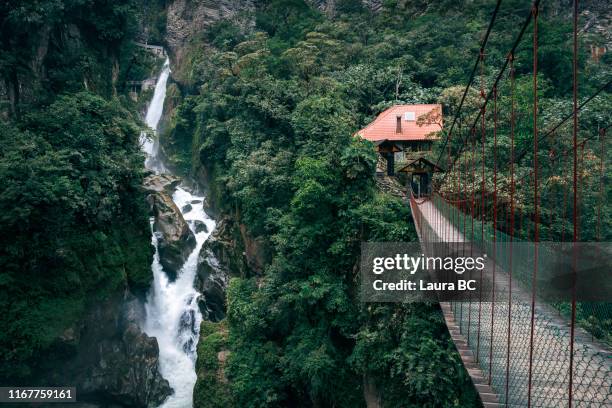 suspension bridge next to a waterfall in ecuador. - ecuador landscape stock pictures, royalty-free photos & images