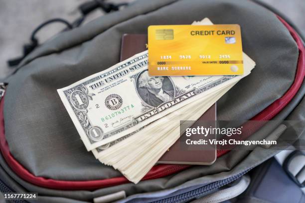 money credit card and passport on the backpack - carte bancaire voiture photos et images de collection