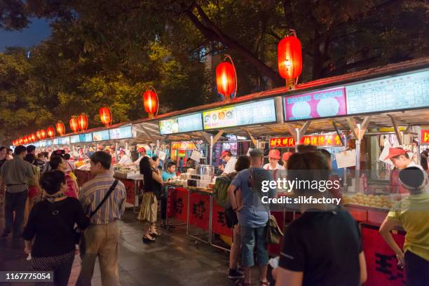 donghuamen night market snack street near wangfujing in beijing - wangfujing stock pictures, royalty-free photos & images