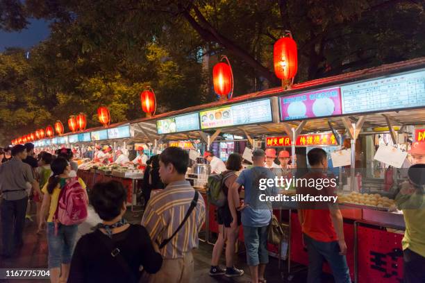 donghuamen night market snack street near wangfujing in beijing - wangfujing stock pictures, royalty-free photos & images