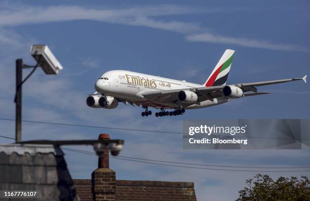 An Airbus SE A380 passenger aircraft, operated by Emirates Airline, passes a CCTV camera as it prepares to land at London Heathrow Airport in London,...