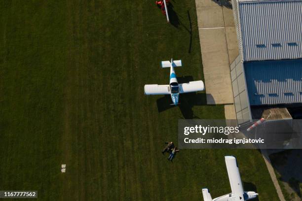 drone point view van vader en dochter liggend op gras op de privé luchthaven - jet lag stockfoto's en -beelden