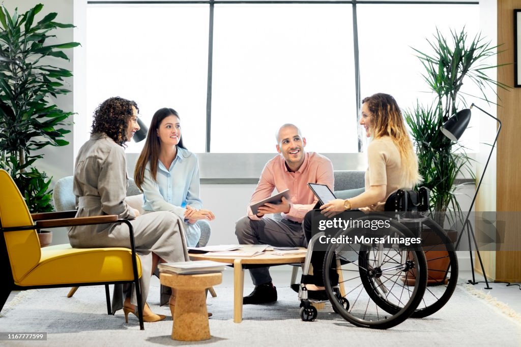 Disabled professional with coworkers in meeting