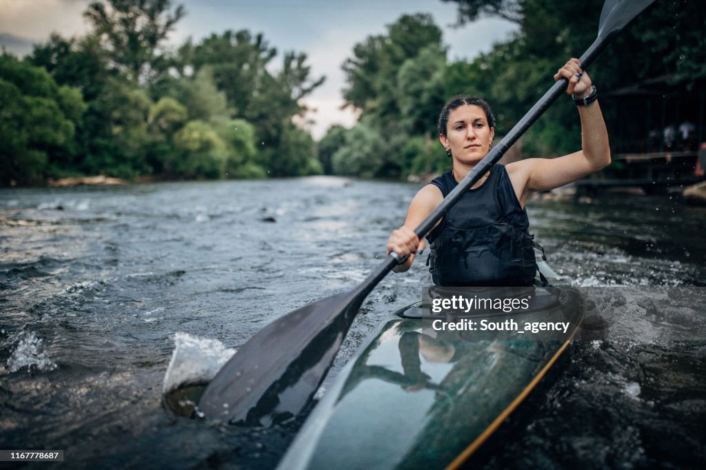 Woman sails in a kayak