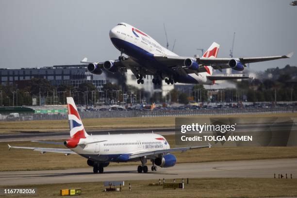 British Airways aeroplane takes off from the runway at Heathrow Airport's Terminal 5 in west London, on September 13, 2019. - British Airways has...