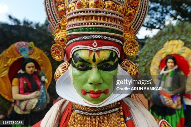 Performers take part in a 'Kummati Kali', mask dance, part of the annual Onam festival celebrations in Thrissur district in the Indian state of...