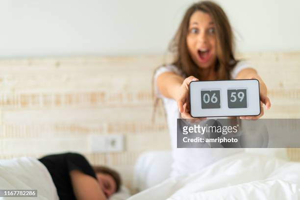 too late awaking woman with alarm clock in bed - daylight savings stock pictures, royalty-free photos & images