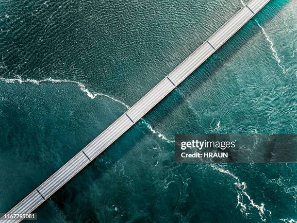 bridge in iceland going over the sea seen from above - bridge imagens e fotografias de stock