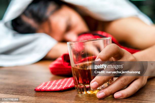 alcohol addiction - drunk businessman holding a glass of whiskey - drunk asian women stock pictures, royalty-free photos & images