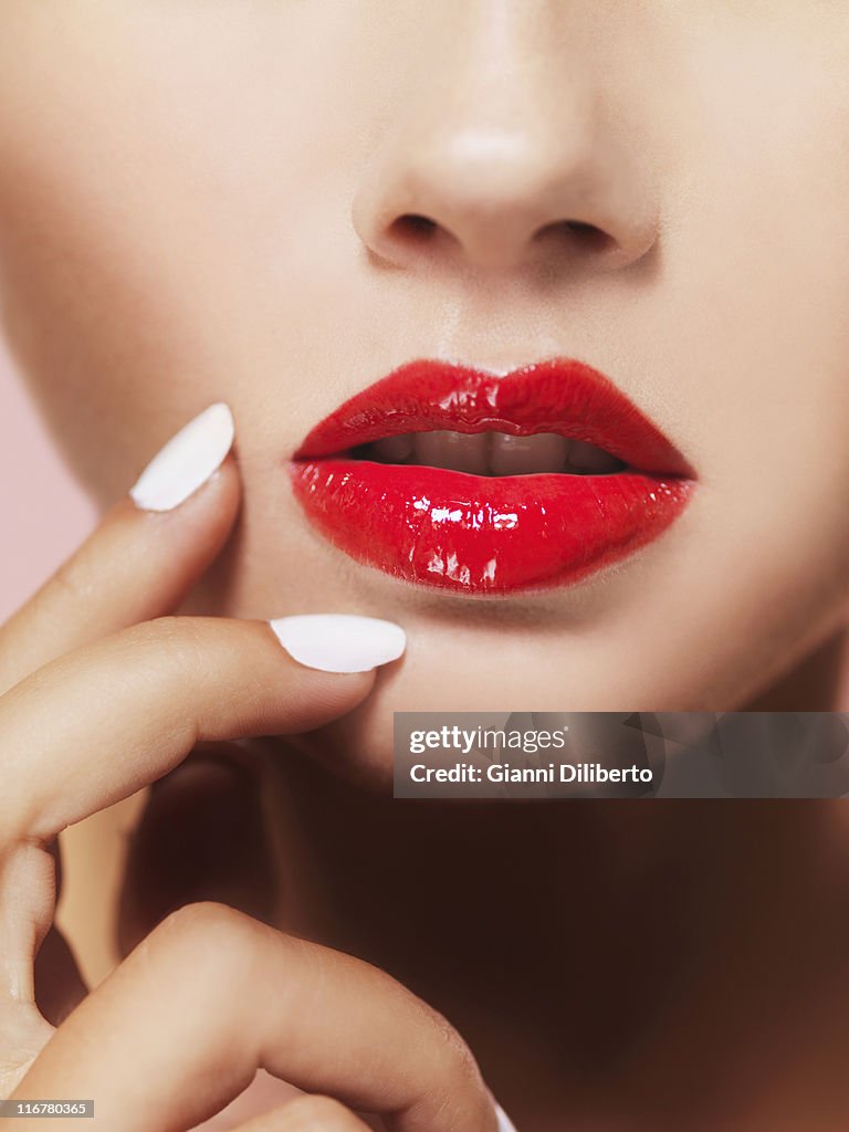 A woman's lips with bright red lipstick, close-up of mouth