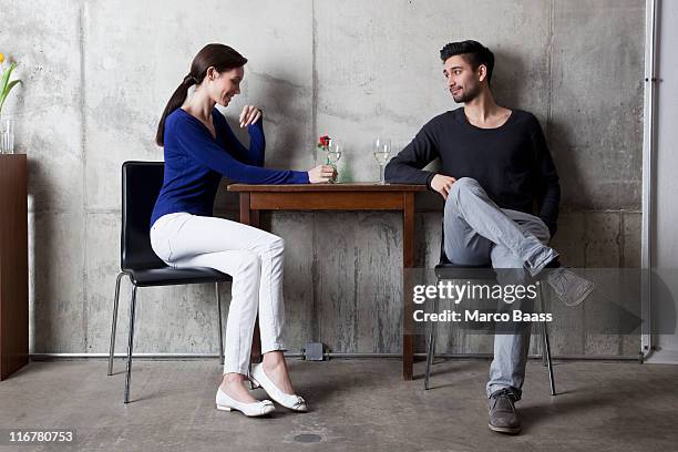 a couple enjoying a glass of wine in a restaurant - flirten stock-fotos und bilder