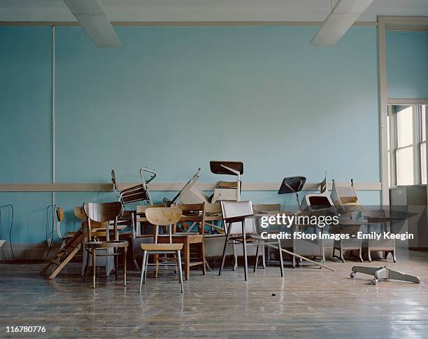 old, broken chairs in an abandoned school - vintage classroom stock-fotos und bilder