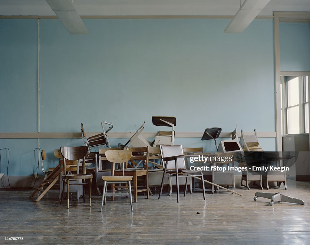 Old, broken chairs in an abandoned school