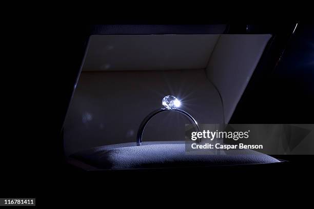 a spot lit engagement ring in a jewelry box, close-up - diamond ring stock pictures, royalty-free photos & images