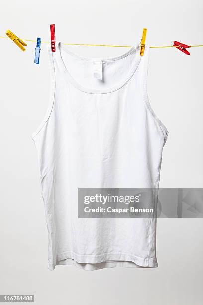 white tank top hanging on clothes line - unterhemd stock-fotos und bilder