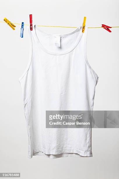 white tank top hanging on clothes line - camiseta de tirantes fotografías e imágenes de stock