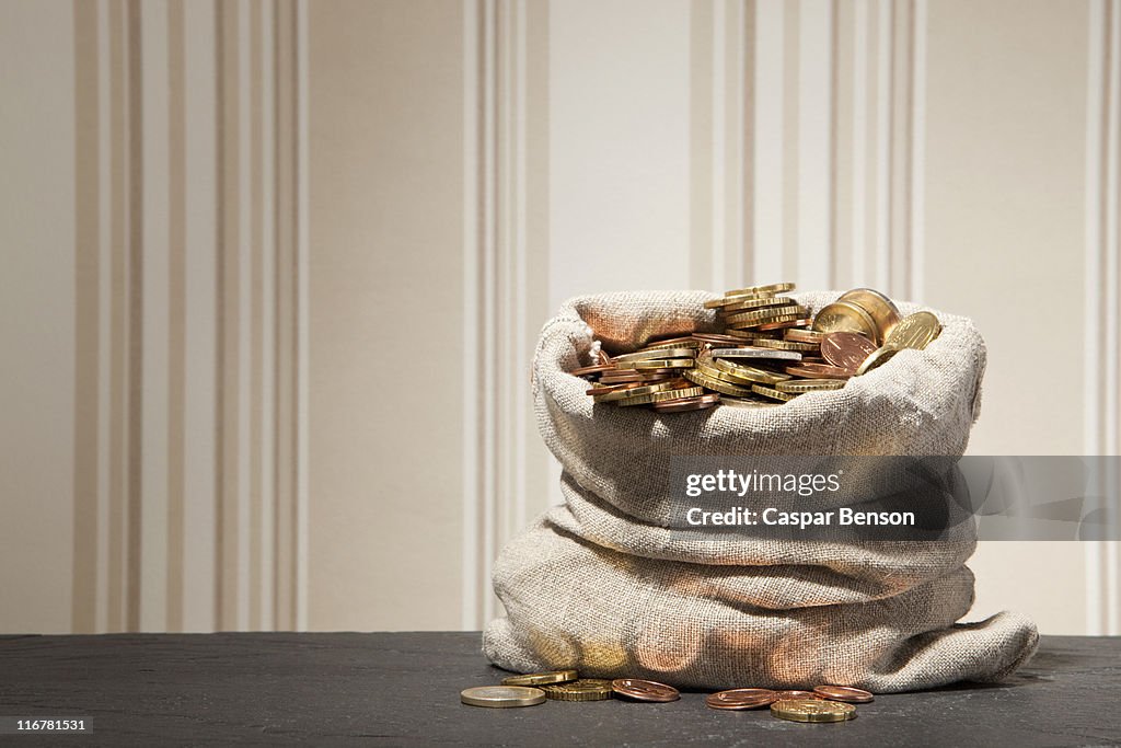 Large sack full of euro coins on a table