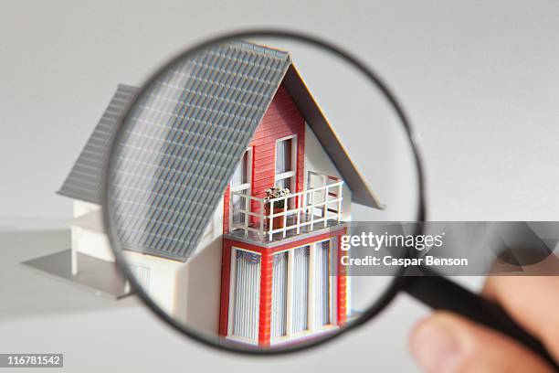 a model house viewed through a magnifying glass - miniature dollhouse bildbanksfoton och bilder