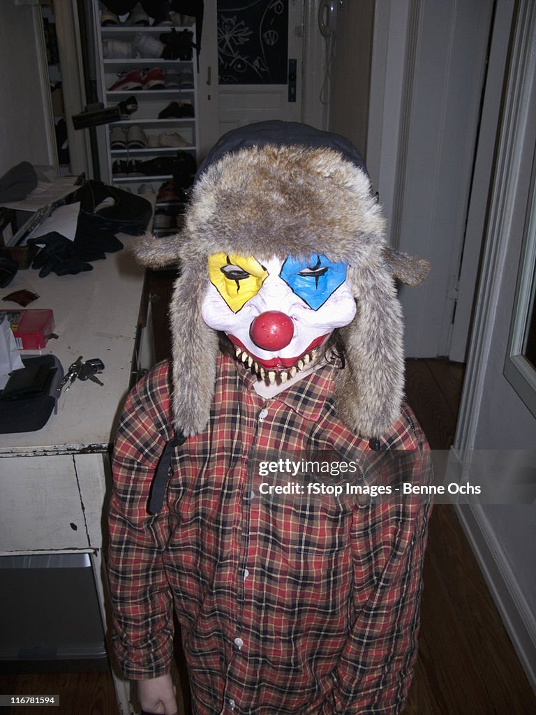 Kid with scary clown mask.