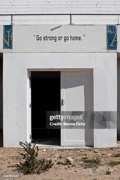 'go strong or go home' sign above door. - stadium entrance stock pictures, royalty-free photos & images