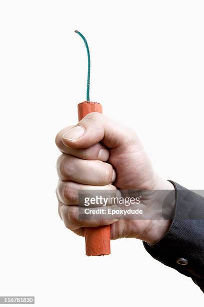 a man holding out a stick of dynamite, close-up of hand - dynamite - fotografias e filmes do acervo